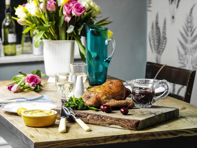 Roast duck crown with a cherry and red wine sauce and dauphinoise potatoes